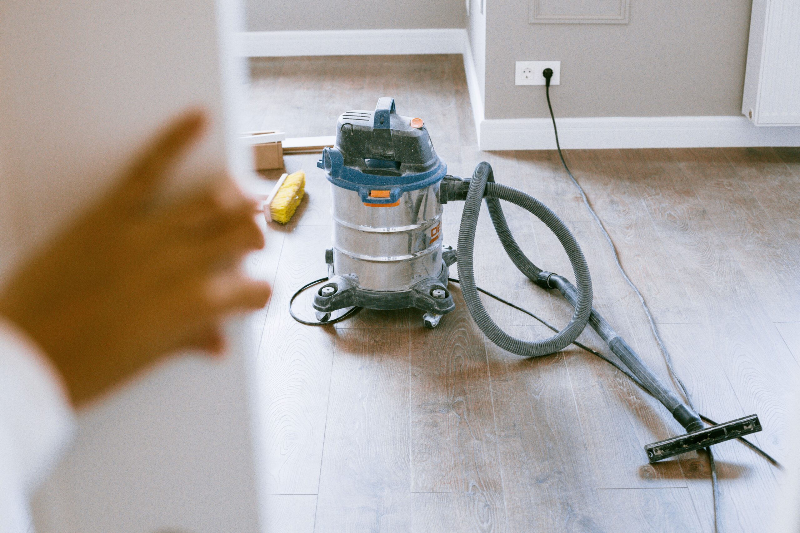 A person doing a fast daily tidy-up routine in a small apartment