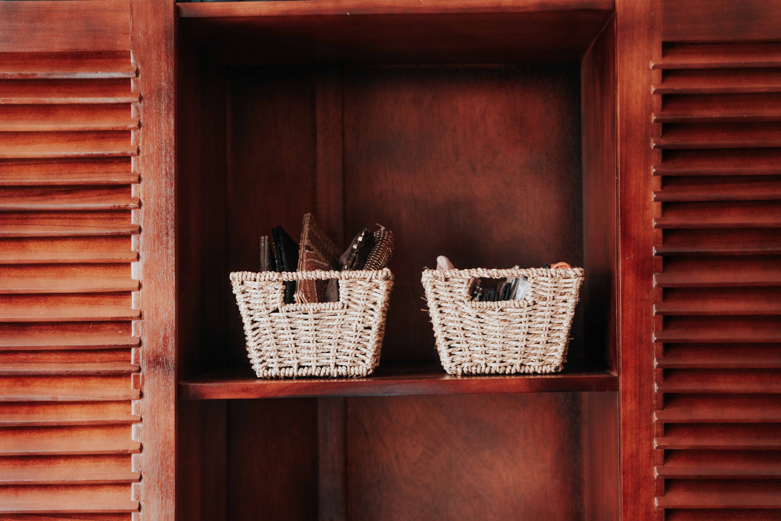 Woven storage baskets on a shelf organizing pet supplies